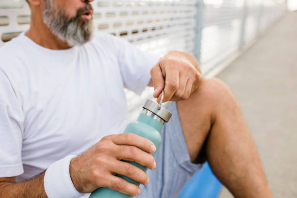 istock Senior man drinking water after intensive workout 1428027864