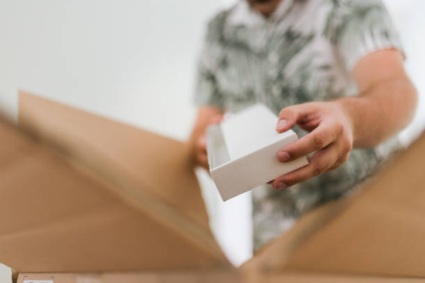 istock A young man is packing and unpacking as he is moving into a new house. 1428027989
