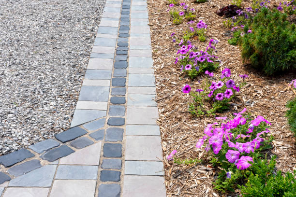 istock Hardscape detail from an elegant luxury landscaping installation using cobblestones and precast flagstone look pavers. 1428028021