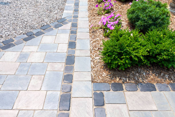 istock Hardscape detail from an elegant luxury landscaping installation using cobblestones and precast flagstone look pavers. 1428028049