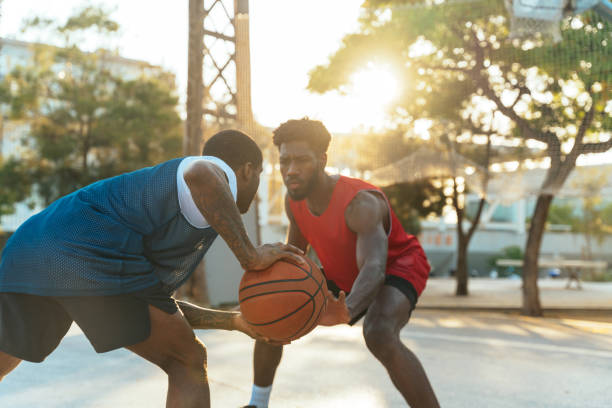 Young basketball players training at the court. stock photo