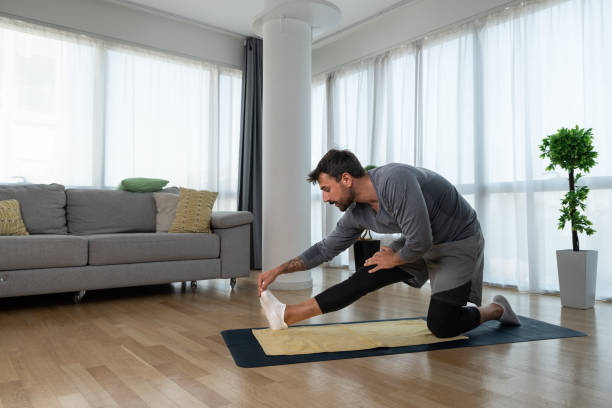 istock Young man cancer survivor practicing home workout yoga training, stretching muscles and breathing exercise for healthy life after long struggle with sickness and pain. 1428036902