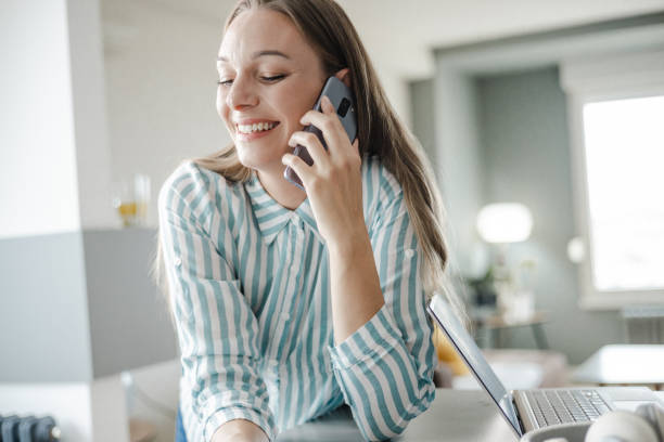 istock Woman talking on the phone at home 1428037563
