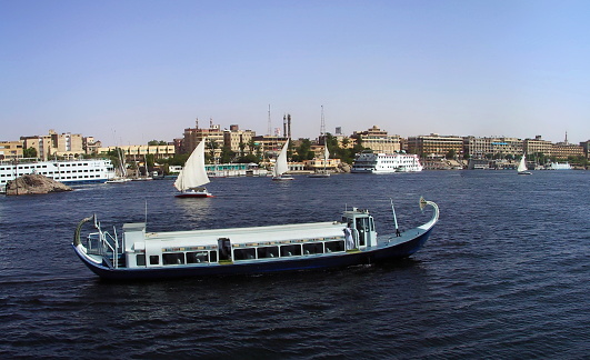Aswan, Egypt. Panoramic view of Tourists crossing the Nile from Elephantine Island to  Aswan City by using the hotel ferry boat.
