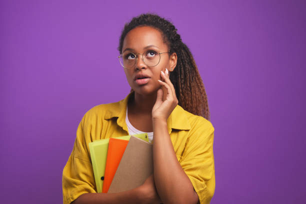 istock Young perplexed African American woman freelancer holds folders with documents 1428038849