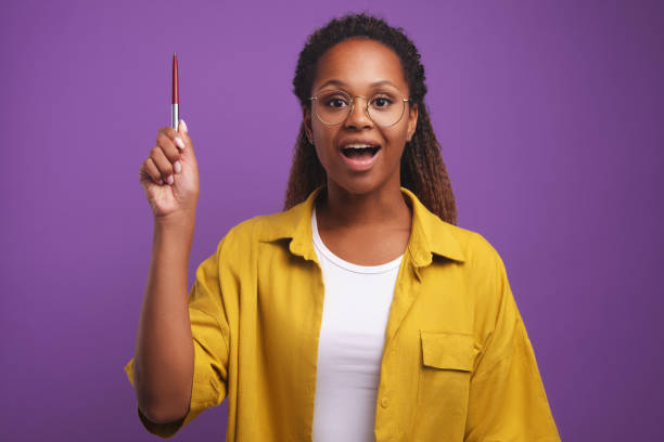 istock Young African American woman opens mouth having come up with interesting idea 1428039068