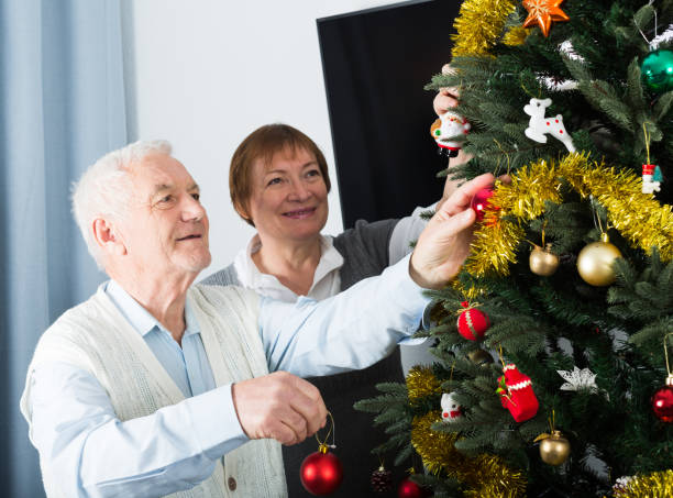 istock Elderly couple decorate fir-tree 1428041254