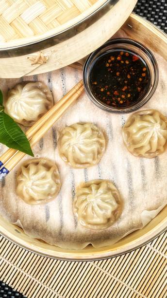 istock Cooked Dim Sum In A Bamboo Steamer With Soy Sauce and Chopsticks 1428044540