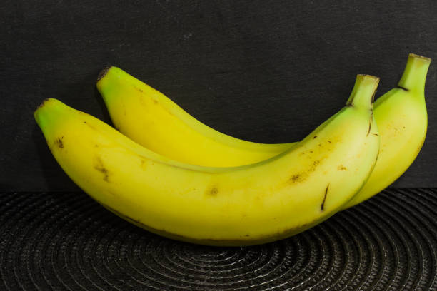 istock Natural ripe banana against dark background 1428047337