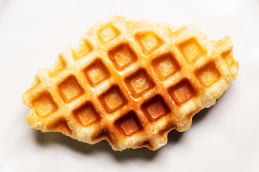 Croffle (croissant and waffle). Mix and match delicious menu. Top view isolated on white marble background.