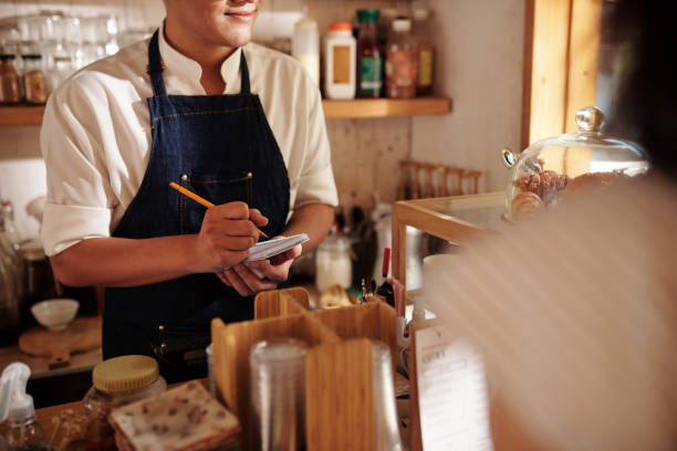 Coffeeshop Waiter Accepting Order stock photo