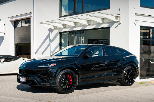 A Lamborghinis Urus SUV is parked at a Lamborghini dealership in Vancouver BC Canada on a sunny day
