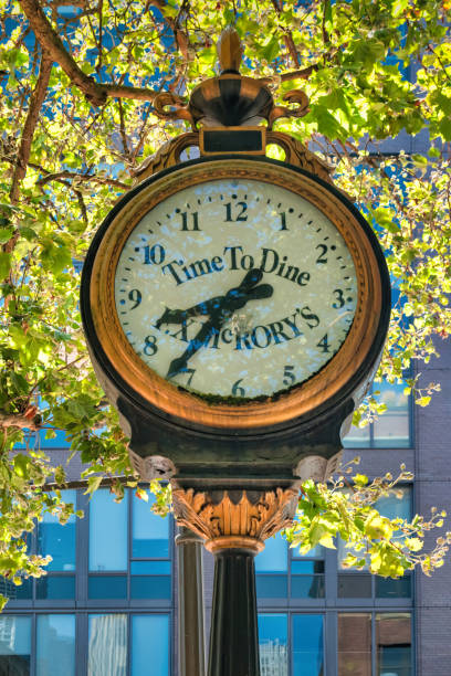 Round clock on building wall against blue sky background
