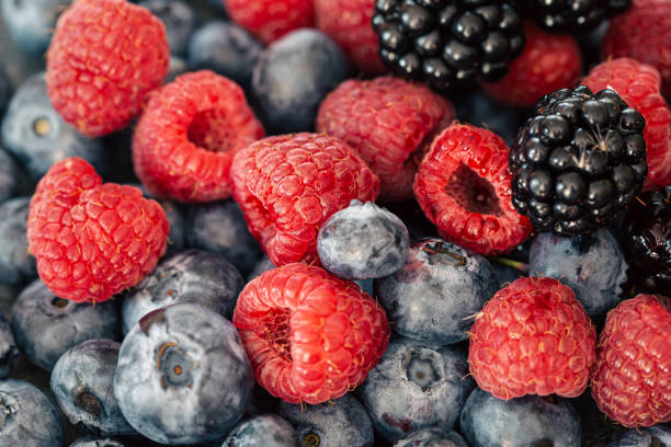 istock Background from different berries, raspberries, blueberries and blackberries. 1428061837