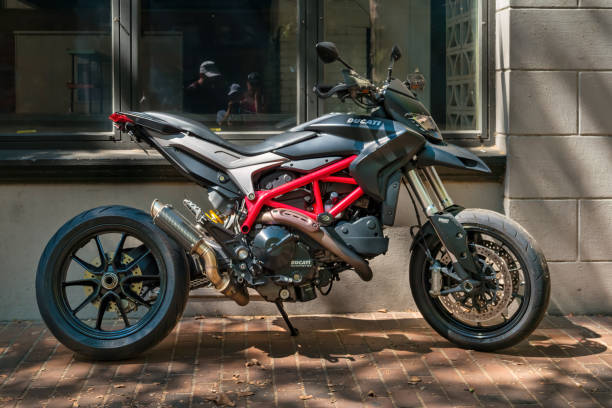 A Ducati Hypermotard 821 motorcycle is parked on a street in downtown Seattle, Washington, USA on a sunny day.