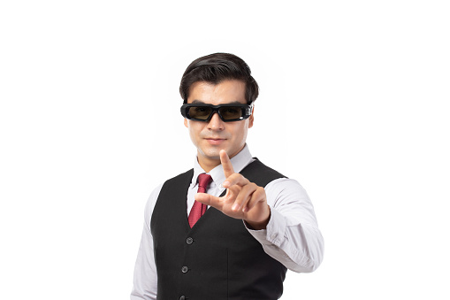 Businessman in a suit with virtual reality VR glasses hand touching virtual global internet connection metaverse on his head isolated on white background.