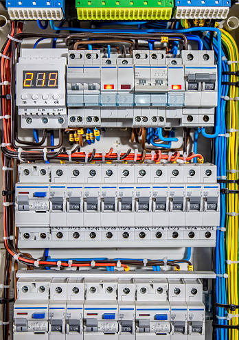 Switchboard equipment. Shield for enterprise electrification. Switchboard for control over electrical equipment. Labeled panel with wires and switches at enterprise.