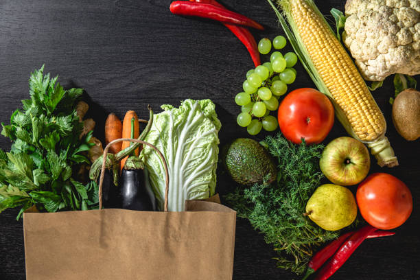istock Flat lay, vegetables and fruits on a black background. 1428073188