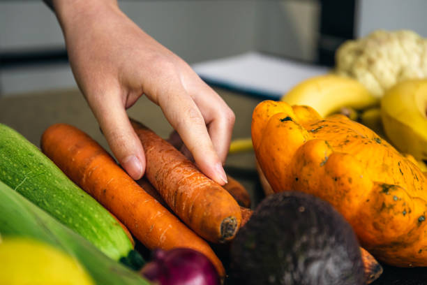 istock Close-up, a woman's hand takes a carrot for cooking. 1428074134