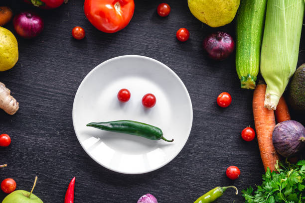 istock Flat lay, vegetables on a wooden background and an plate with paper. 1428074166