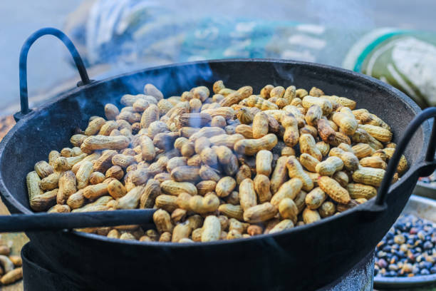 istock A peanut seller keep frying peanut on a van, fried peanuts. 1428075711