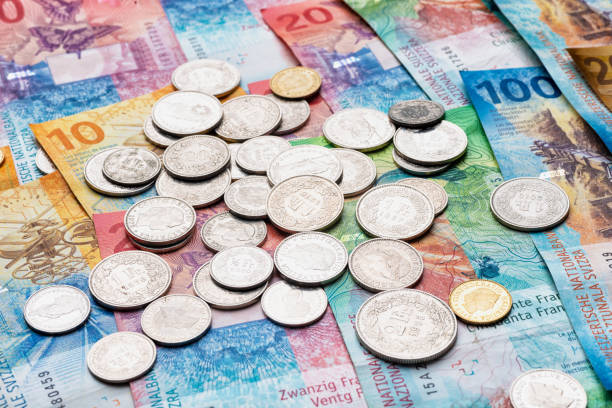 istock Swiss franc coins on banknotes currency CHF Switzerland 1428076963
