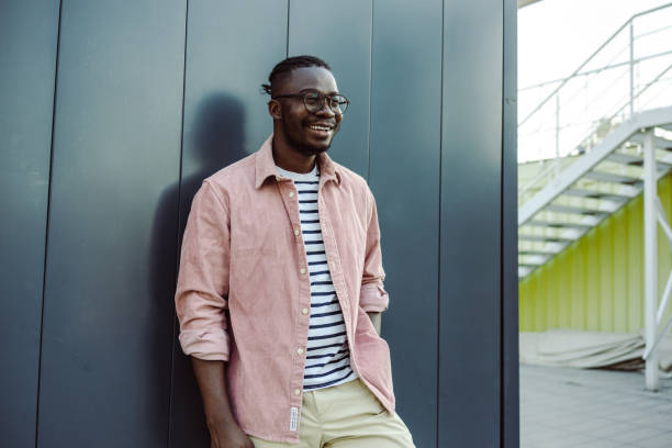 istock A young African American man standing in front grey wall 1428078089