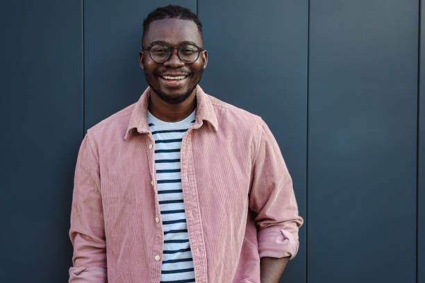 istock A young African-American man standing in front gray wall 1428078208