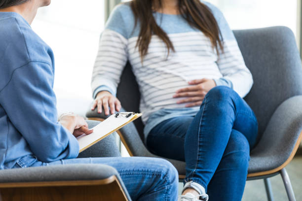istock Female therapist and unrecognizable expectant mom talk about pregnancy 1428081316