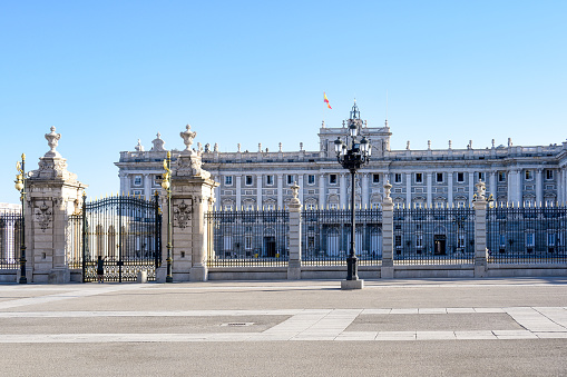 Madrid, Spain – April, 4, 2014: Tourists walking and visiting the royal palace of Madrid in spring.