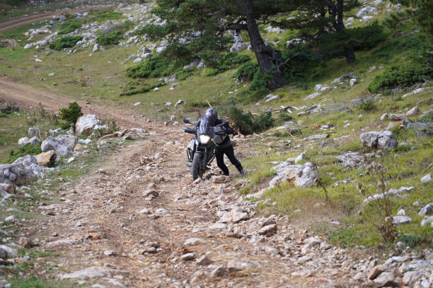 istock A man riding an off-road motorcycle on a mountain road 1428081390