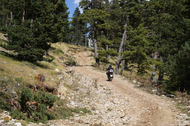 istock A man riding an off-road motorcycle on a mountain road 1428081392