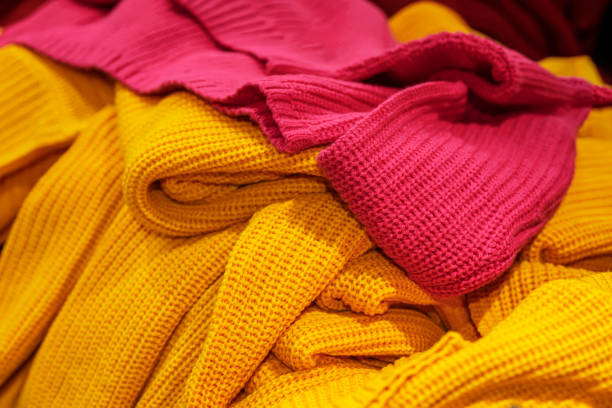 istock Knitted pullovers, yellow and red. Autumn and winter shopping 1428082037