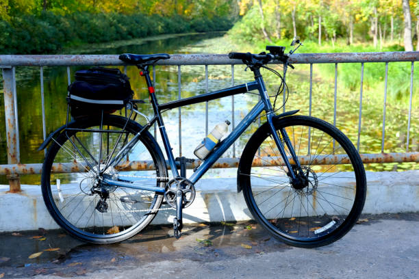 istock One mountain bikes propped on iron bridge next to beautiful river on autumn forest. 1428082286