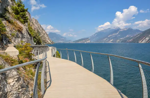 Magnificent modern cycling and walking path along Lake Garda - Ciclopista del Garda, which offers magnificent views of the lake and mountains. Brescia, Italy.