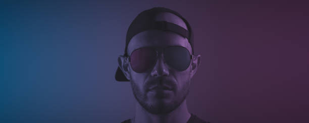 istock Brutal man in sunglasses. Blue-purple lighting 1428084037
