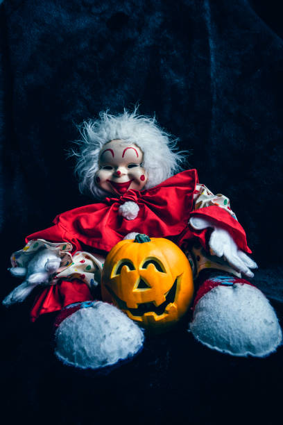 istock Creepy Clown Doll With Jack O Lantern for Halloween 1428085007