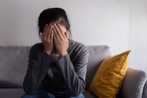 istock Depressed Asian Woman Covered Her Face With Her Palm with Sadness 1428085277
