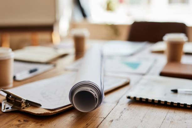 istock Empty office desk with architecture blueprint, documents and paper for house, home or shopping mall building design. Architect business office table used for planning, work and collaboration teamwork 1428088689