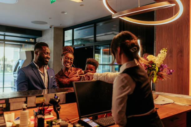 istock Happy family getting key card at hotels front desk. 1428092971