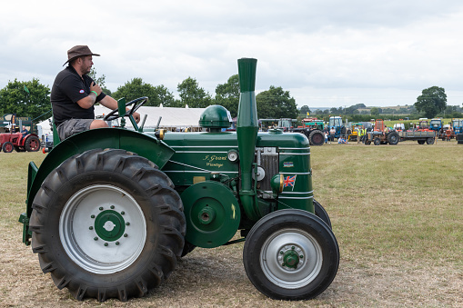 Ilminster.Somerset.United Kingdom.August 21st 2022.A restored Field Marshal tractor is being driven at a Yesterdays Farming event