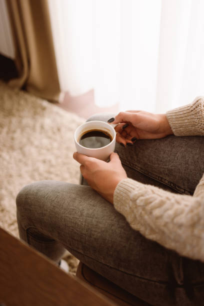 istock Woman holding cup of coffee 1428094936