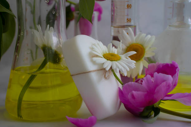 istock Cosmetic soap, chamomile flower, peony on a light background 1428097863