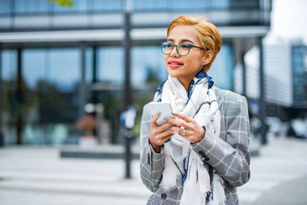 istock Young woman using smart phone in the city 1428098882