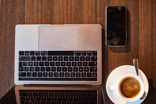 High angle view of laptop,coffee cup and mobile phone at the table