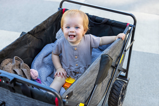 Happy toddler having a wagon ride