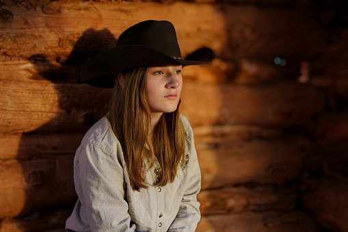 Young Cowgirl Portraits in Old Cabin - Environmental portrait in rural area with old barns and cabins.