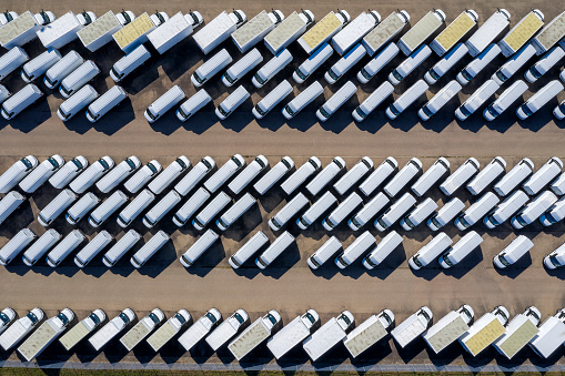 White delivery vans viewed directly from above.