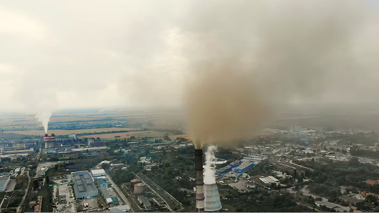 CHERKASY, UKRAINE, SEPTEMBER 12, 2018: Big Power plant , factory with pipes, expelling smoke into sky. Smoke from industrial chimney. ecology, pollution of the environment. High quality photo