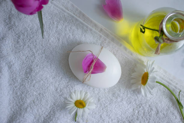 soap stack with chamomile flower on white wood table